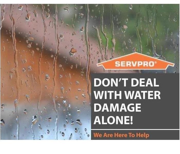 Rain on a window with text and SERVPRO logo